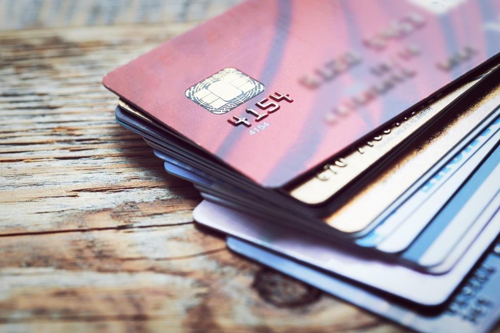 Set of color credit cards on wooden table